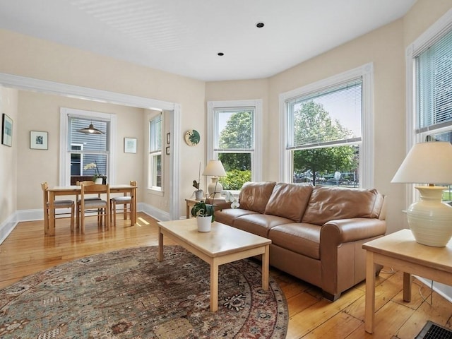 110 Woerd Ave, Waltham, MA 02453 - living area with light wood-style floors and baseboards
