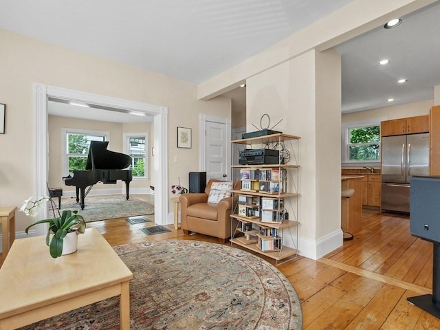 110 Woerd Ave, Waltham, MA 02453 - living room featuring light wood finished floors and recessed lighting