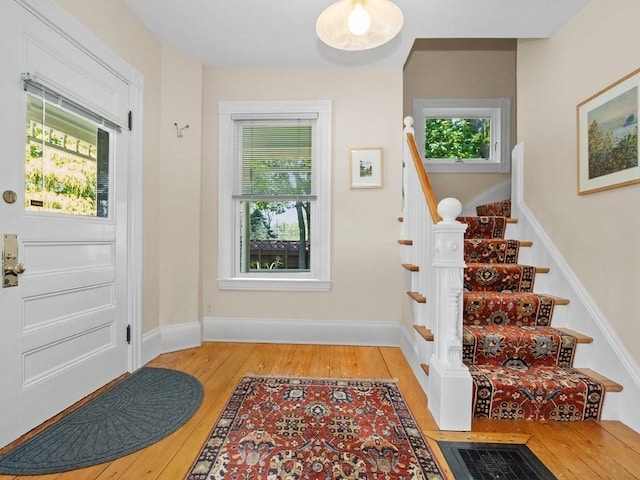 110 Woerd Ave, Waltham, MA 02453 - foyer entrance with stairs and wood finished floors