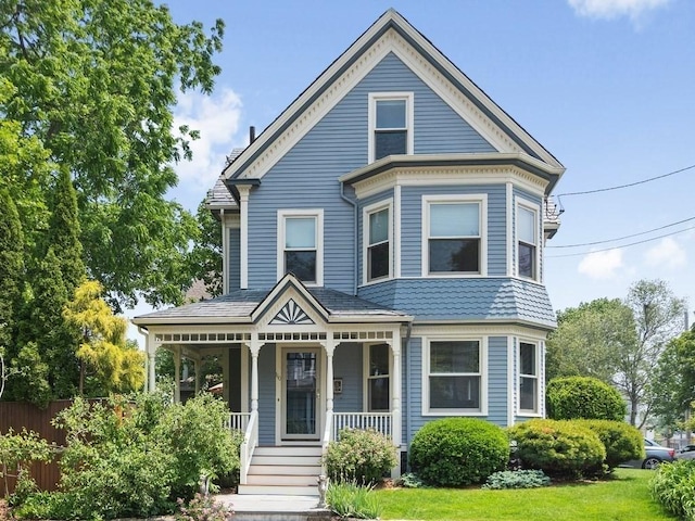 110 Woerd Ave, Waltham, MA 02453 - victorian-style house featuring covered porch
