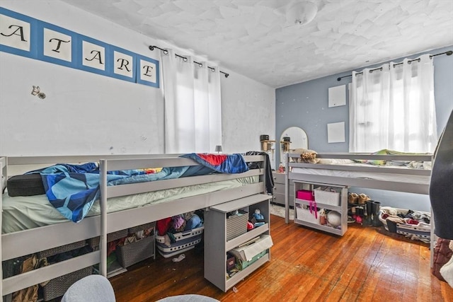 bedroom featuring hardwood / wood-style flooring and multiple windows