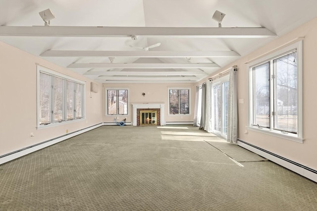 unfurnished living room with lofted ceiling with beams, a baseboard radiator, baseboard heating, and a healthy amount of sunlight