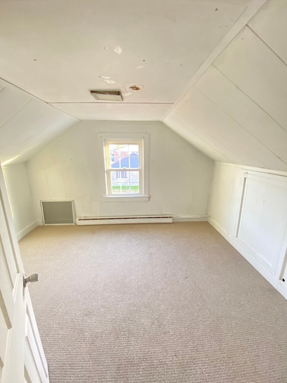 bonus room with light colored carpet, lofted ceiling, and a baseboard heating unit