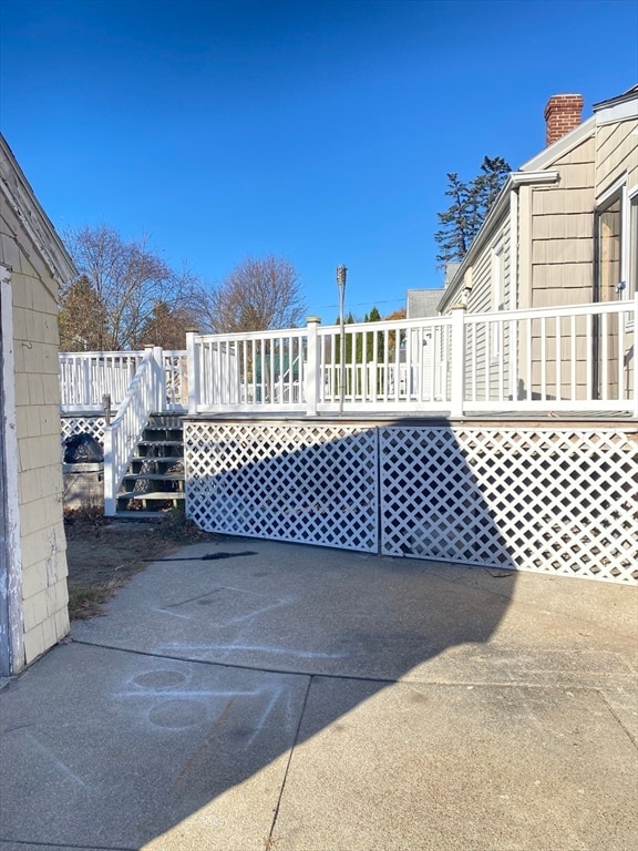 view of gate with a wooden deck