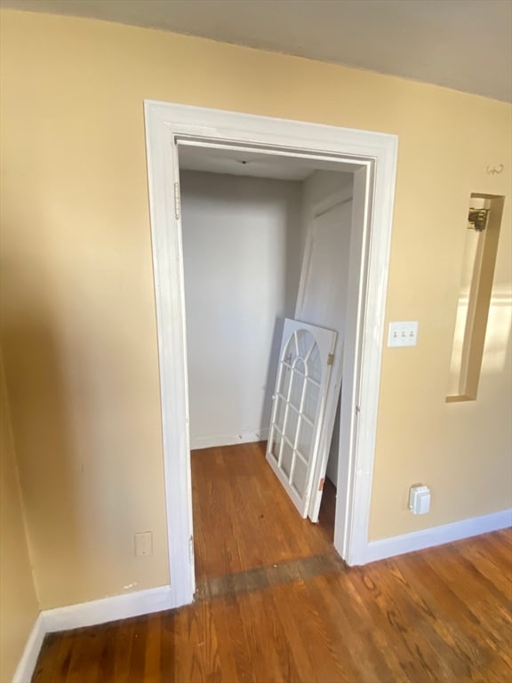 hallway with dark hardwood / wood-style floors