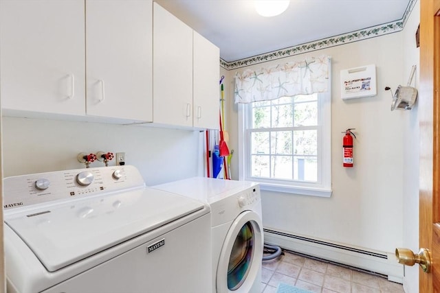 laundry room with cabinets, a baseboard heating unit, and washing machine and clothes dryer