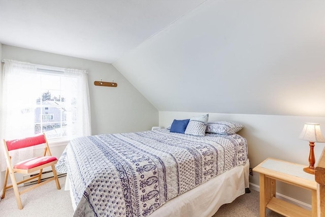 bedroom with carpet floors, baseboard heating, and vaulted ceiling