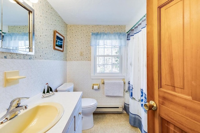 bathroom with vanity, a baseboard radiator, toilet, and tile walls