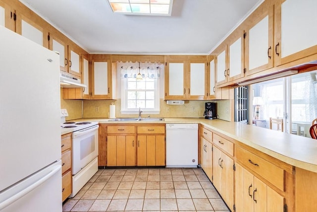 kitchen featuring backsplash, sink, light tile patterned flooring, and white appliances