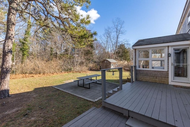 deck with a lawn and a storage shed