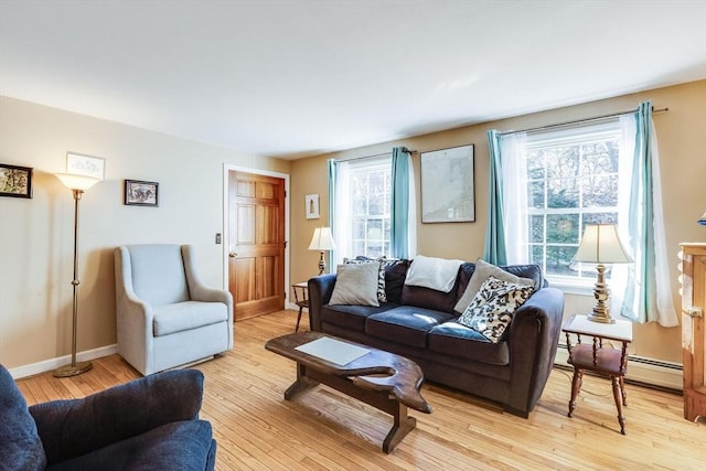 living room featuring light hardwood / wood-style floors and a baseboard heating unit