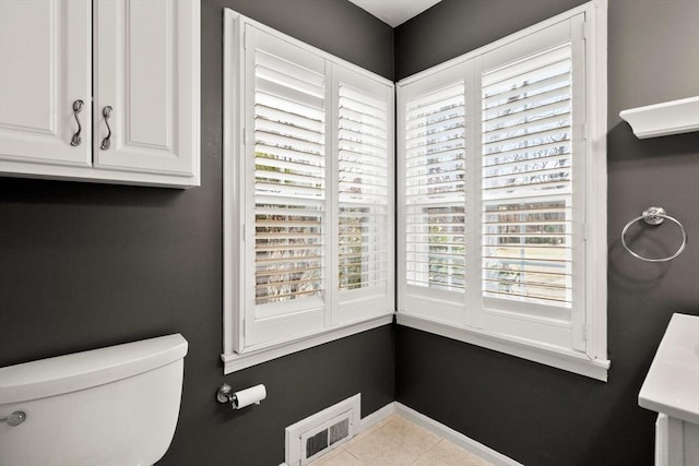 bathroom featuring tile patterned flooring, plenty of natural light, and toilet