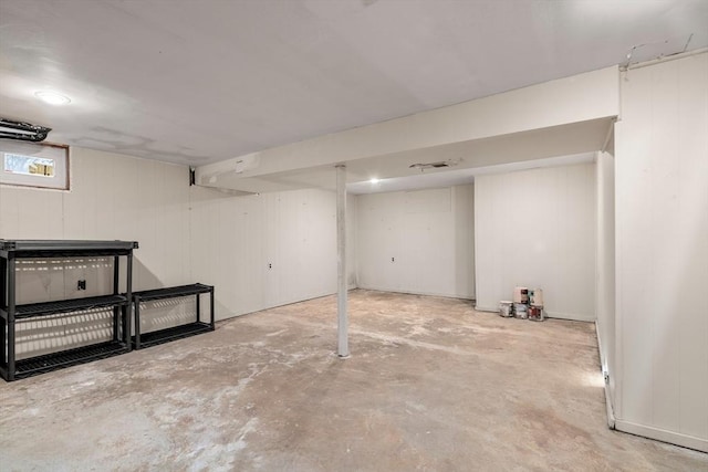 basement featuring wood walls