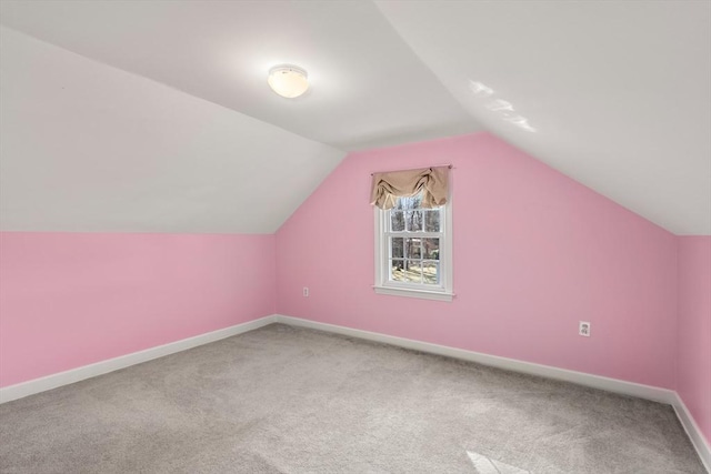 additional living space featuring carpet and lofted ceiling