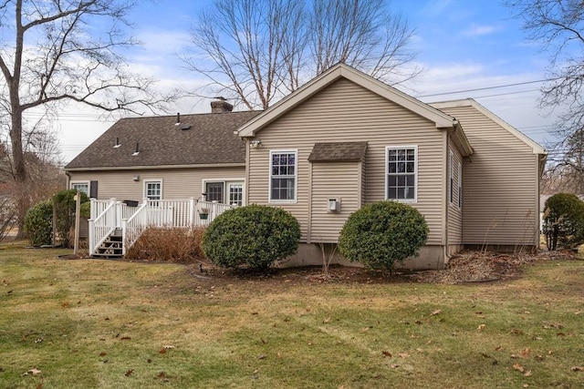 back of house with a lawn and a deck