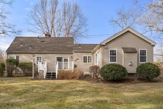 rear view of house with a yard and a deck