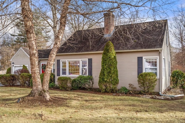 view of front of home with a garage and a front lawn