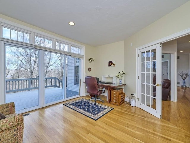 office space with recessed lighting, wood finished floors, visible vents, and french doors