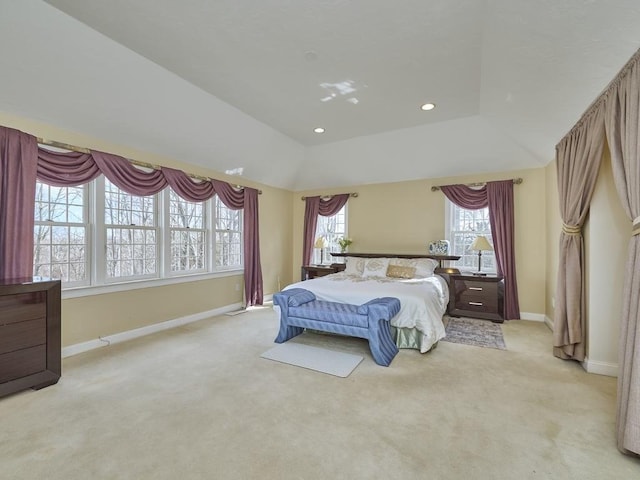 bedroom featuring light carpet, lofted ceiling, a tray ceiling, recessed lighting, and baseboards