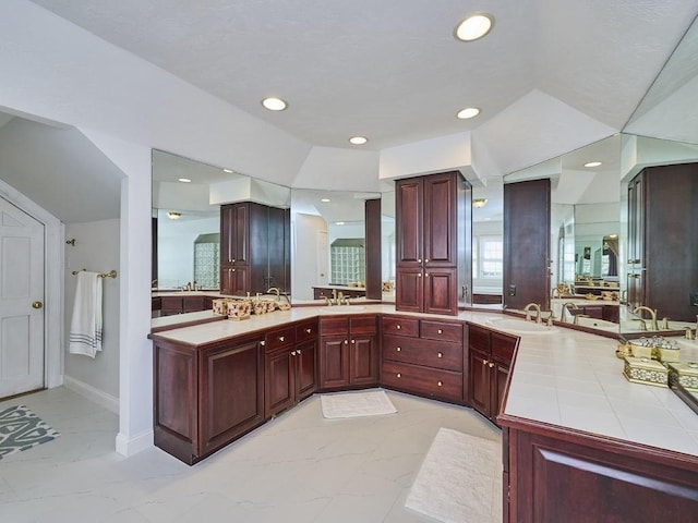 full bathroom with vanity, recessed lighting, marble finish floor, and baseboards