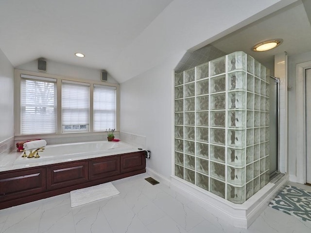 full bath featuring marble finish floor, a shower stall, a garden tub, and vaulted ceiling