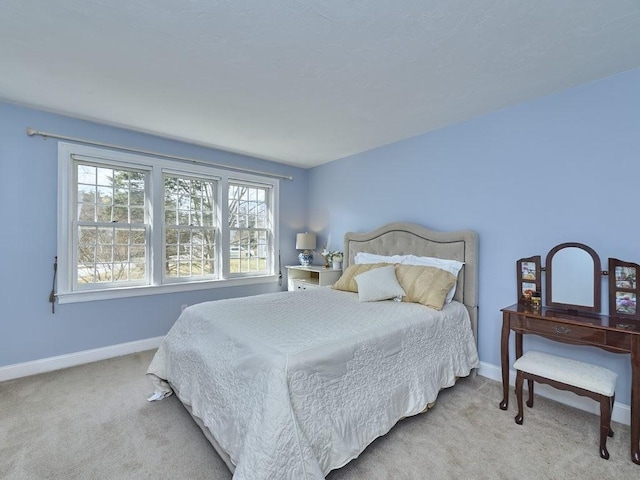 carpeted bedroom with baseboards