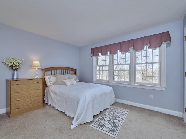 bedroom featuring baseboards and carpet floors