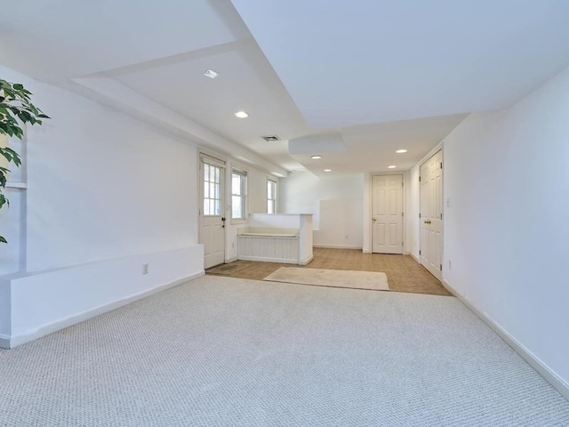 spare room with recessed lighting, visible vents, baseboards, and light colored carpet