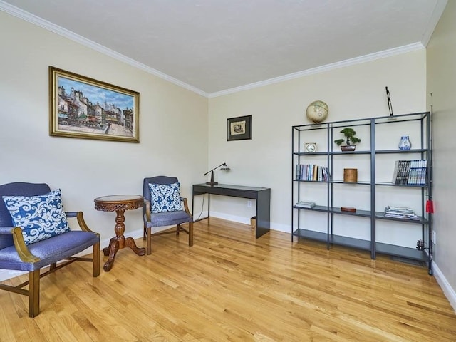 living area with light wood-type flooring, baseboards, and ornamental molding