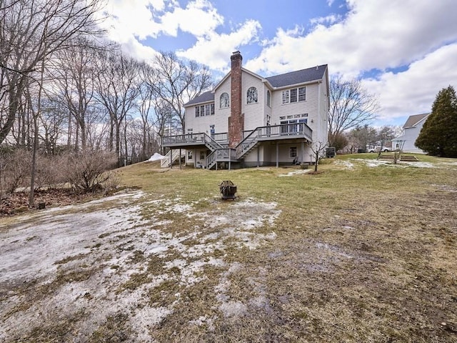 view of property exterior with a lawn, a deck, an outdoor fire pit, stairway, and a chimney