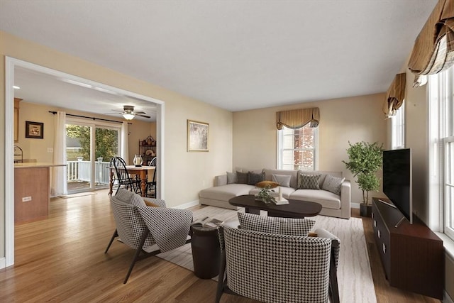 living room featuring light wood-type flooring and a healthy amount of sunlight