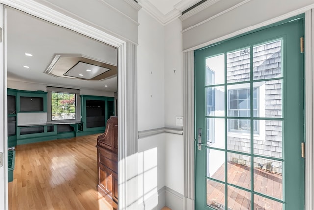 entryway featuring light hardwood / wood-style floors and ornamental molding