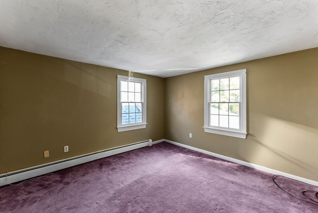 carpeted empty room featuring a baseboard heating unit and a textured ceiling