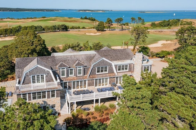 birds eye view of property featuring view of golf course and a water view