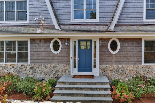 entrance to property featuring stone siding