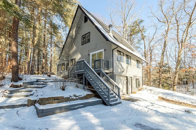 view of front of home featuring a deck and a garage