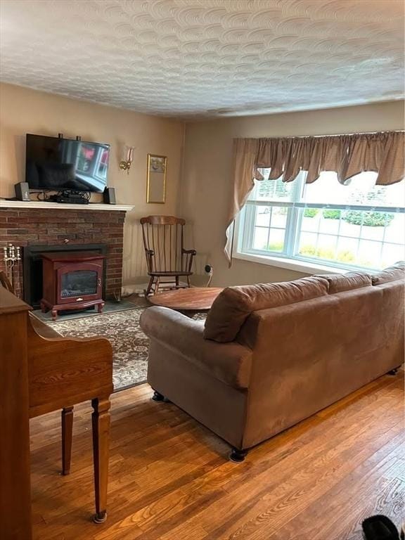 living room with wood-type flooring and a textured ceiling