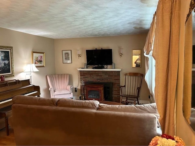 living room with a brick fireplace, hardwood / wood-style floors, and a textured ceiling