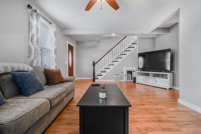 living room featuring ceiling fan and hardwood / wood-style flooring