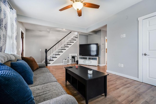 living room with hardwood / wood-style floors and ceiling fan