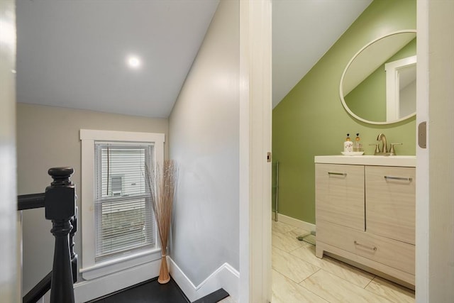 bathroom with vanity and vaulted ceiling