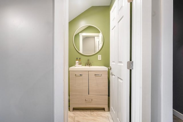 bathroom featuring vanity and vaulted ceiling