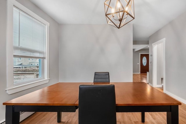 dining room featuring wood-type flooring and a notable chandelier