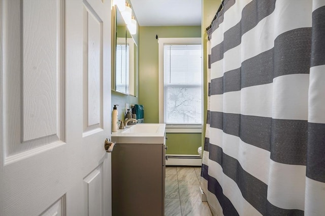 bathroom with vanity and a baseboard radiator