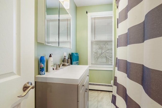 bathroom featuring vanity, ceiling fan, and a baseboard heating unit