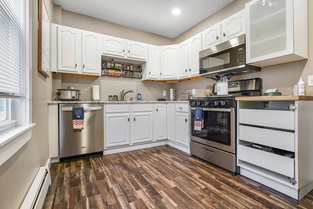 kitchen featuring stainless steel appliances, a baseboard heating unit, sink, dark hardwood / wood-style floors, and white cabinetry