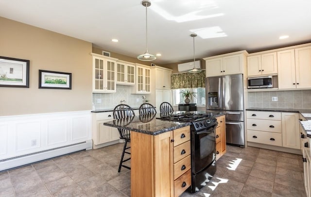 kitchen featuring pendant lighting, a center island, a kitchen breakfast bar, baseboard heating, and stainless steel appliances