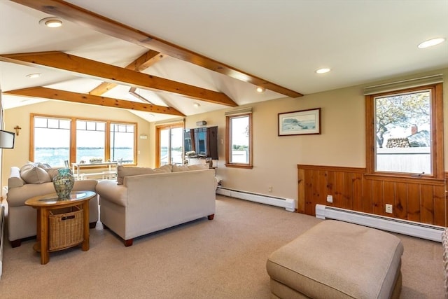 carpeted living room featuring vaulted ceiling with beams, wood walls, and a baseboard heating unit