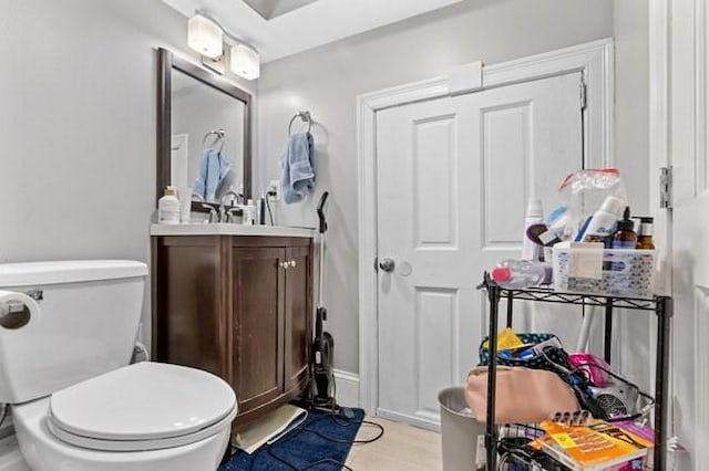 bathroom featuring vanity, toilet, and wood finished floors