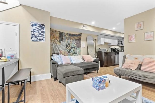 living room with light wood-style floors and baseboards